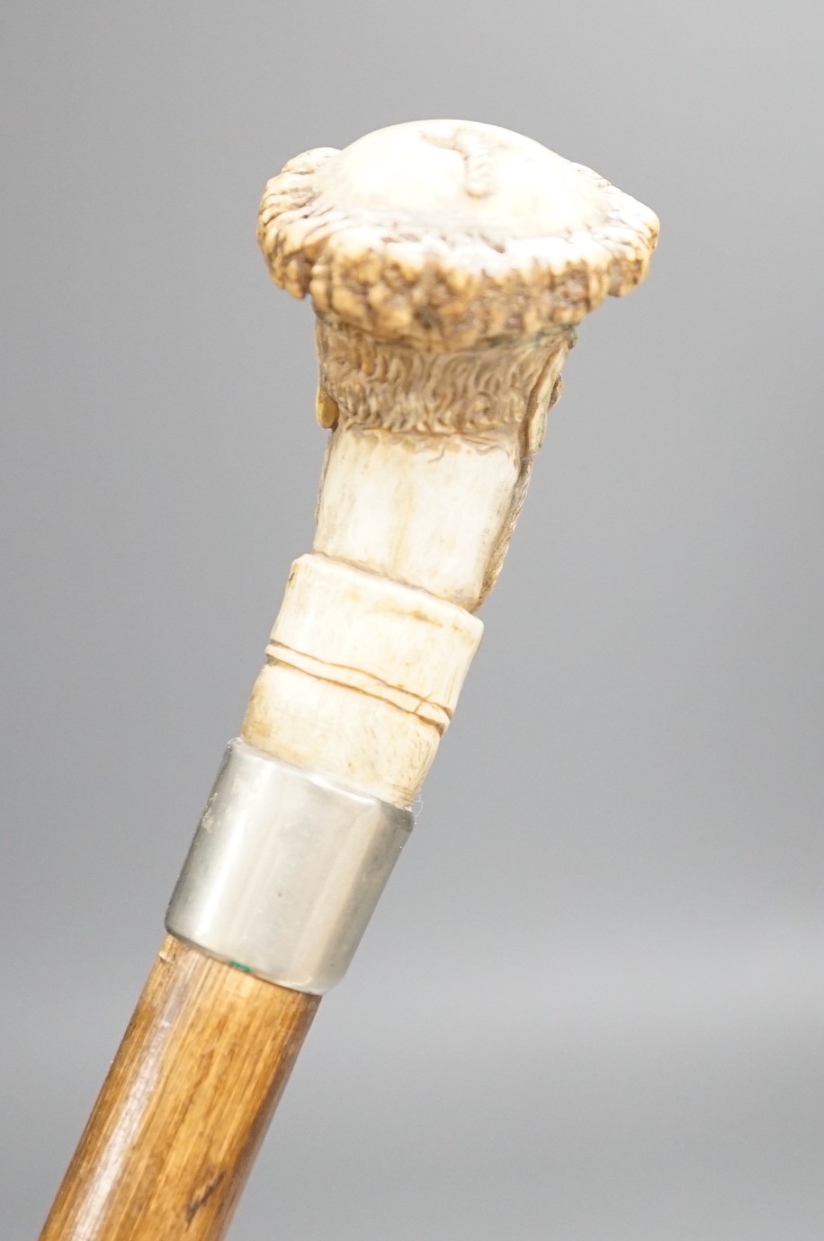 A novelty carved stag horn handled cane, of a large nosed gent, 78cms long